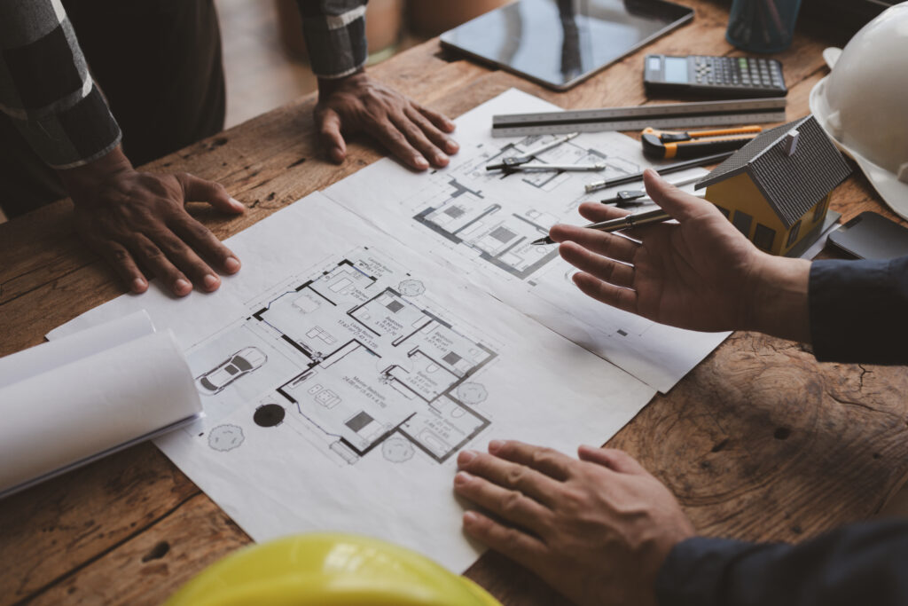 The home design architects are reviewing the house plan draft, t